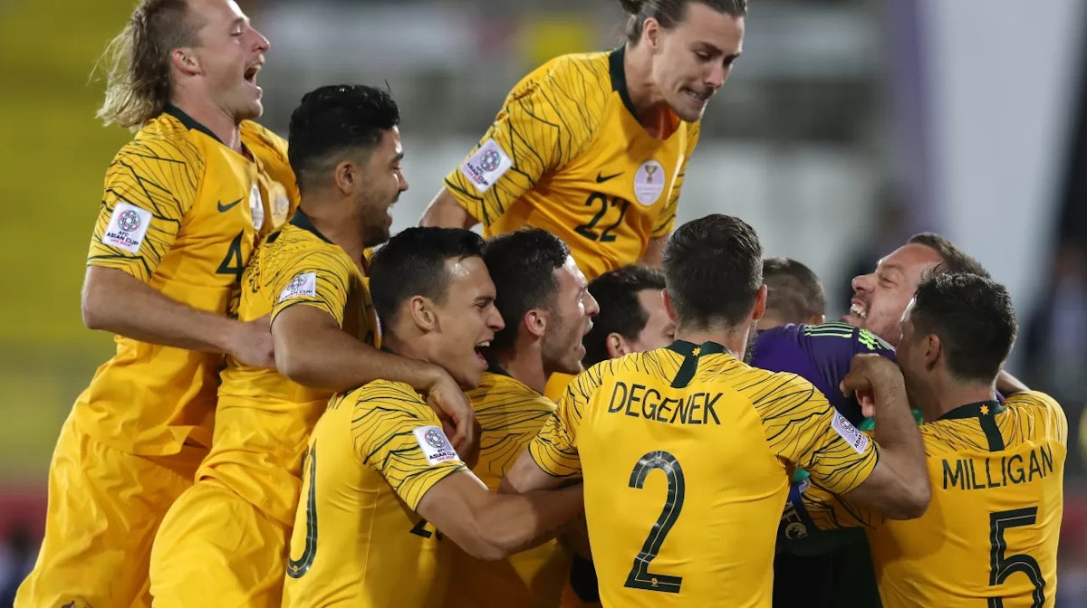 Mat Ryan of Australia (hidden) celebrates with his teammates following their sides win after a penalty shoot-out in the AFC Asian Cup round of 16 match between Australia and Uzbekistan at Khalifa Bin Zayed Stadium - Getty Images