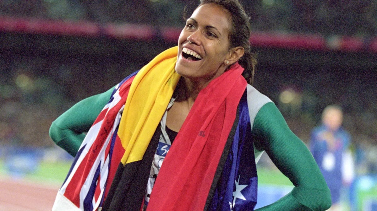 Catherine Freeman with the Australia and Aboriginal flags