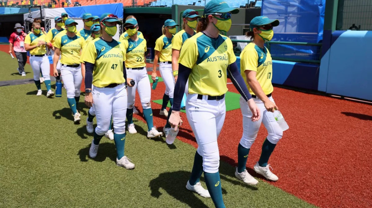 Team Australia walk on the field with their masks on after their opening round game against Team Japan during the Tokyo 2020 Olympic Games at Fukushima Azuma Baseball Stadium on July 21, 2021 in Fukushima, Japan. Team Japan defeated Team Australia 8-1. (P