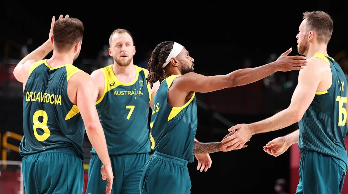 Patty Mills #5 of Team Australia congratulates his teammates following their victory over Italy in a Men's Preliminary Round Group B game on day five of the Tokyo 2020 Olympic Games at Saitama Super Arena