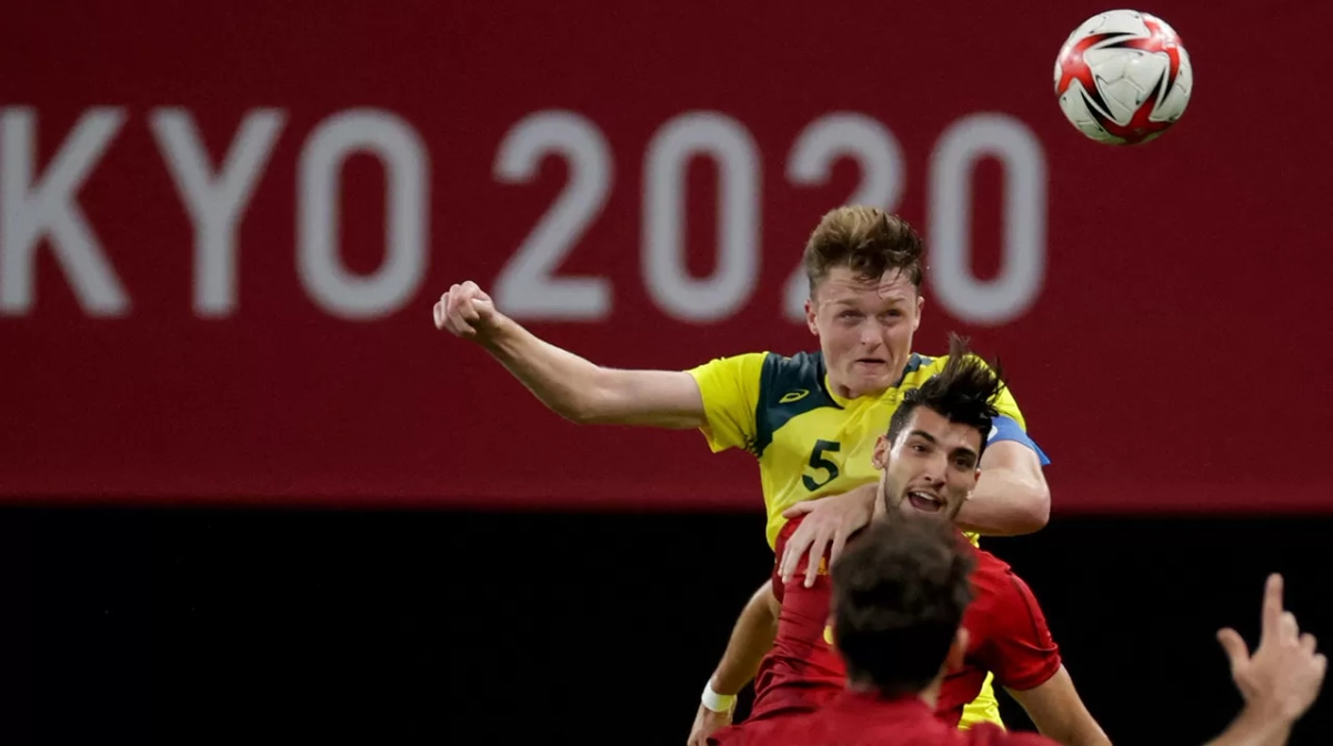  Harry Souttar (top) fights for the ball with Spain's forward Rafa Mir (middle) during the Tokyo 2020 Olympic Games men's group C first round football match between Australia and Spain at Sapporo Dome in Sapporo