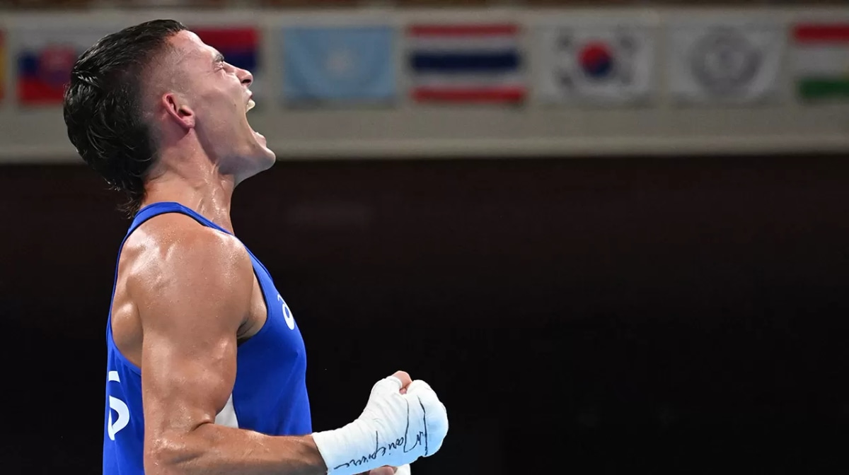 Harrison Garside celebrates after winning against Kazakhstan's Zakir Safiullin after their men's light (57-63kg) quarter-final boxing match during the Tokyo 2020 Olympic Games at the Kokugikan Arena in Tokyo